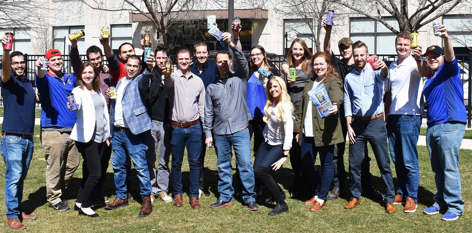 The Tiesta Tea team outdoors, raising Tiesta Tea tins